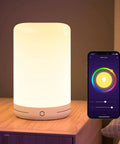 Smart LED Bedside Lamp with App Control, Voice Assist, RGB Color Changing Mood Light on USB on a wooden nightstand with phone app