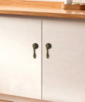 Antique Brass Door Handle Set 2.44 By 0.94 Inches Ten Pack With Tear-Drop Knobs Solid Zinc Construction Vintage Bronze Finish on cabinet