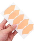 Self Adhesive Heel Protectors Soft Foam Cushion Pads For Shoes Wear Resistant Anti Blister Heel Grips Stick On Foot Care For Sore Heels And Ill Fitting Kicks Top Tier Protection in light brown, held in hand.