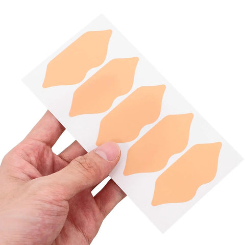 Self Adhesive Heel Protectors Soft Foam Cushion Pads For Shoes Wear Resistant Anti Blister Heel Grips Stick On Foot Care For Sore Heels And Ill Fitting Kicks Top Tier Protection in light brown, held in hand.