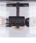 Nash 3 Bulb Semi Flush Light With Seeded Glass in Oil Rubbed Bronze Finish, showing Edison bulbs against a clear seeded glass shade.