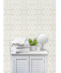 Workhorse Symmetrical Wallpaper With Pvc Free Type Ii Rating And Matte Texture Boasting Sturdy Linen Vibes For Busy Kitchens Bathrooms And Commercial Spaces Using Paste To Paper Installation For Pro Level Daily Results in beige with stacked towels and plant.