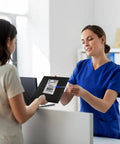 Person handing over Six By Ten Inch Bubble Mailers 100 Pack Black Padded Envelopes Waterproof Self Seal Opaque at a counter.