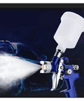 Mini Air Paint Sprayer With Slick 0.8 And 1.0mm Tips For Straight Smooth Finishes On Cars And Walls featuring a clear reservoir and fine mist.