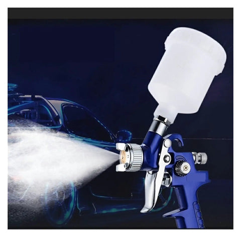 Mini Air Paint Sprayer With Slick 0.8 And 1.0mm Tips For Straight Smooth Finishes On Cars And Walls featuring a clear reservoir and fine mist.