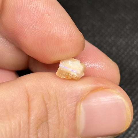 Hand holding Spencer Idaho Pink Opal Rough Cutting Material Dope Multicolor Loose Gem 70.80 Cts 11x8x5 mm for jewelry making