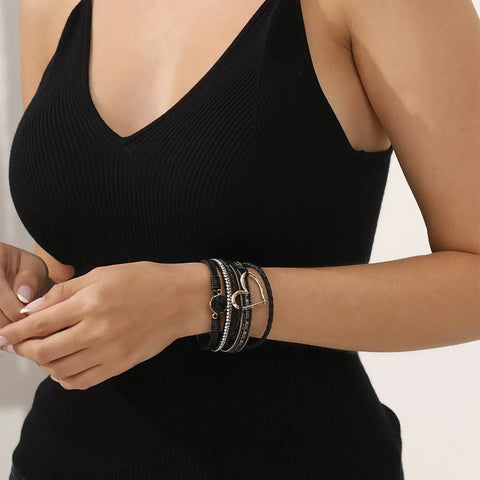 Killer Boho Western Leather Wrap Bracelet For Women With Layered Cuff Strands Heart Stone Charm worn by a woman in a black top.