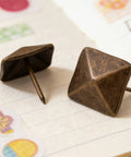 Top Shelf Antiqued Brass Upholstery Nails With Dang Sharp Square Cone Heads Heavy Duty Furniture Tacks Pack Of Thirty on notebook