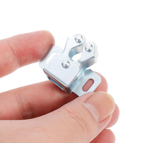Close-up of hand holding a piece from the 35Pcs Door Ball Catch Cabinet Hardware Kit With Cold Rolled Steel Double Roller Latches For Quiet Operation.