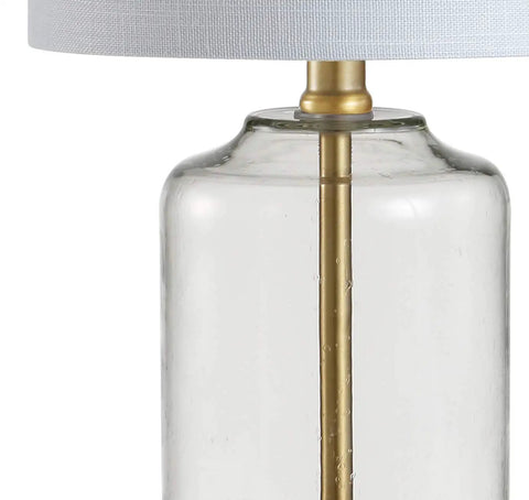 Close-up of Brass Gold and Clear Glass Table Lamp with White Linen Drum Shade, showing glass base and brass accents