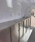 Interior view of Custom Designed Concession Food Truck Trailer With Turnkey Kitchen Layout And Heavy Duty Stainless Steel Body, featuring stainless steel setup.