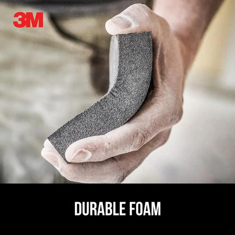 Person holding Dual Grit Drywall Sanding Sponge For Medium Remove And Fine Smooth Flexible Foam Block angled view