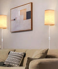 Plug In Wall Sconce Set of Two With 3 Color Modes Warm White Soft White Daylight White Industrial Vintage Vibe Wall Lights With On Off Switch For Bedroom Living Room Hallway Porch, installed above a beige couch with decorative pillows and a framed abstract art piece on the wall.