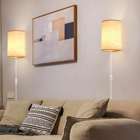 Plug In Wall Sconce Set of Two With 3 Color Modes Warm White Soft White Daylight White Industrial Vintage Vibe Wall Lights With On Off Switch For Bedroom Living Room Hallway Porch, installed above a beige couch with decorative pillows and a framed abstract art piece on the wall.