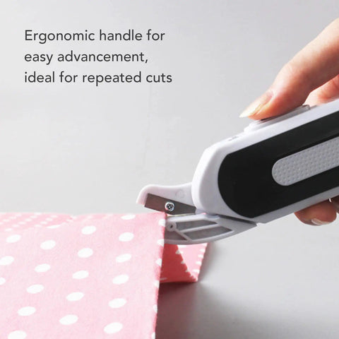 Ultra Slick Cordless Electric Scissors For Fabric Cutting And Crafting Projects delivering comfortable grip for easy cutting on pink fabric.