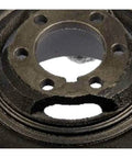 Close-up of black harmonic balancer for Kia Sportage 1995 to 2002, showing six-hole design and keyway for serpentine drive belt