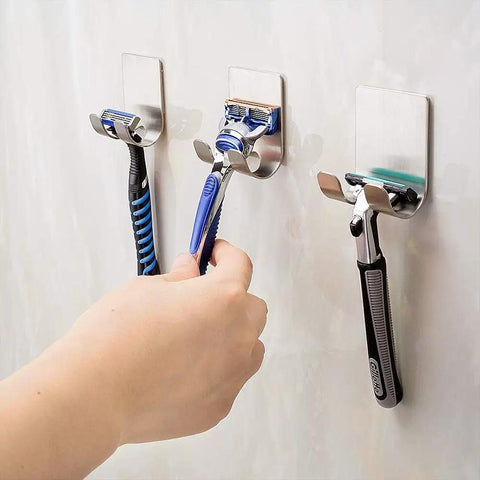 Razor Holder For Shower, Self Adhesive Stainless Steel Razor Hook Hanger, holding three razors with hand reaching one.