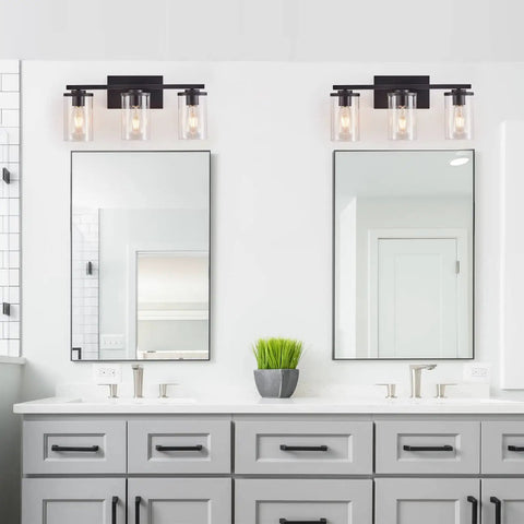 Three Light Vanity Light Fixture With Clear Glass Shades Slick Matte Black Wall Sconce above bathroom mirrors