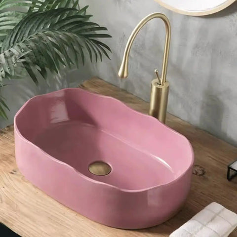 UMJIGF Vessel Sink Household Washbasin Bathroom Above Counter Basin in pink, installed with a golden faucet and wooden countertop.