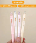 Four Cute Retractable Gel Pens with Glitter Cat Design, 0.5mm Fine Point Black Ink in hand, pink, green, yellow, and purple