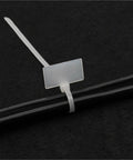 Rock Solid 100 Pack Nylon Self Locking Cable Ties With Write On Labels securing bundled cables with a writable label.