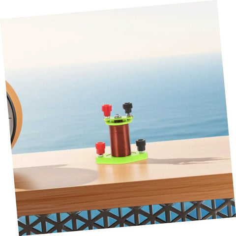 Hands On Induction Coil Kit Two Pack For Physics Lab Dual Coil Transformer Science Set on a wooden table with ocean view