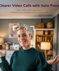 Woman smiling in a home setting, showcasing the Straight Up 1080P HD Webcam With Kickass AI Noise Cancellation.