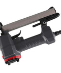 Heavy Duty Pneumatic Brad Nailer With 100 Nail Capacity And Slick Jam Clearing Tech For Smooth Carpentry Woodworking And Diy Projects, angled view showing trigger and loading area.
