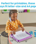 Child using a Magnetic Dry Erase Activity Tray For Kids with paper and magnetic letters in a classroom setting.