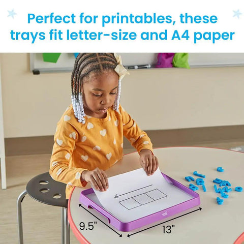 Child using a Magnetic Dry Erase Activity Tray For Kids with paper and magnetic letters in a classroom setting.