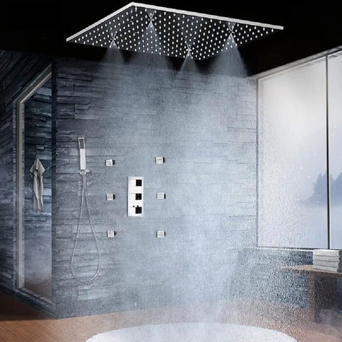 Heavy Duty 20X40 Inch Shower Panel System With Solid Three Knob Thermostatic Mixer And Four Mode Settings Like Rainfall Mist Massage Jets Plus Independent Hand Shower In Classic Antique Brass For A Straight Up Bathhouse Vibe in a modern shower setting with overhead rain and body sprays.