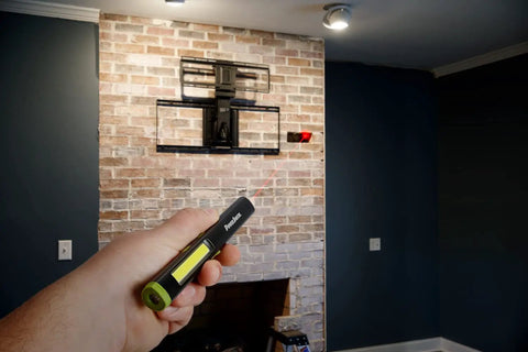 Hand holding Rechargeable Inspection Pen Light With 450 Lumen Flood And 140 Lumen Spot, 365 Nm UV Light near wall