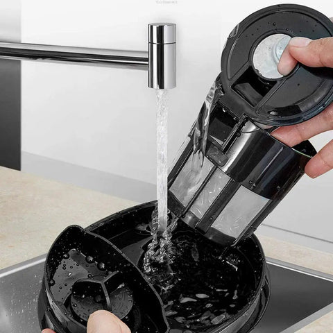 Hassle Free Mini Coffee Maker With Built In Bean Grinder And Glass Carafe, Solid Six Cup Drip Brewer being rinsed under faucet.