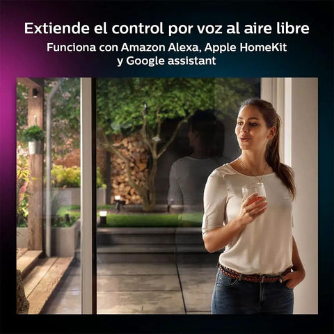 Woman using Hue White And Color Ambiance Outdoor LightStrip 2m 7ft All Weather, controls light with voice command via smart hub