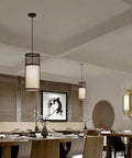 YAXDQUW Modern Style Bamboo Pendant Light Handcrafted Hanging Ceiling Lamp showcased in a dining area with wooden table.