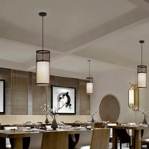 YAXDQUW Modern Style Bamboo Pendant Light Handcrafted Hanging Ceiling Lamp showcased in a dining area with wooden table.