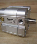 Hydraulic Cylinder 0822 494 101 PN 0822494101 With 1/8 NPT Port and 3/8 In Diameter, compact actuator resting on wooden surface