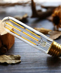 Dimmable T10 Edison LED Tubular Bulb 4000K Daylight White Dope Vintage Filament Light 60W Equivalent E26 Base on wooden surface
