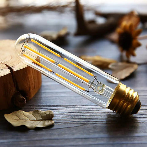 Dimmable T10 Edison LED Tubular Bulb 4000K Daylight White Dope Vintage Filament Light 60W Equivalent E26 Base on wooden surface