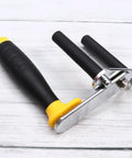 Heavy Duty Gypsum Board Lifter With Widened Alloy Base And Adjustable Angle Design Makes Drywall Installation A Total Snap For Pros Who Need To Haul Plaster Panels Effortlessly And Safely, featuring a black rubber grip handle.