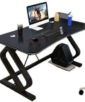 Game Ready Multifunctional Computer Desk With Built In Phone And Drink Slots Curved Gaming Table featuring a matte black surface and monitor setup.