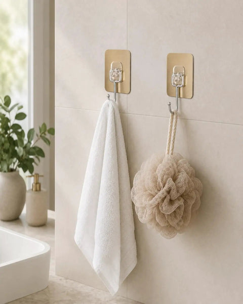 Six Pack Tough Grip Adhesive Wall Hooks Offering No Sweat No Drill Install Slick Gold Square Plate And Clear Hooks holding white towel and beige loofah.
