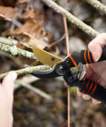 Hands using Heavy Duty Pruning Shears For Garden Work With Foam Grip Handles, Bypass Hand Pruners And Eight Inch Garden Clippers For Plant Cutting And Hedge Trimming, Pro Grade Stainless Steel Blades Cut Up To Three Quarters Of An Inch to cut a branch.