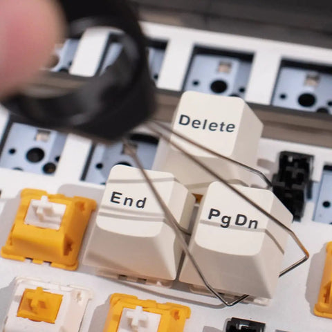 Close-up of Two Layer Switch Lubrication Station for Mechanical Keyboards, showing keycap puller with Gateron switch keycaps.