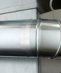 High-temperature flue tape on a silver metal duct seam for sealing joints.