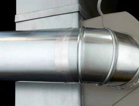 High-temperature flue tape on a silver metal duct seam for sealing joints.