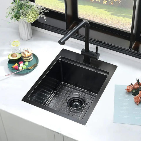 15 Inch Drop-In Bar Sink Workstation With Solid Wood Cutting Board in black stainless finish in kitchen counter setting.
