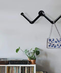 Wall-mounted shelf using Six Pack Three Quarter Inch 24 Inch Black Metal Pipes Pre Cut For Do It Yourself Industrial Shelving And Home Decor
