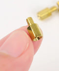 Hardcore Heavy Duty M3 Hex Brass Standoff Spacers 10 Piece Set Male Female Threaded Screws in hand, showcasing precision details.