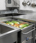 Heavy Duty Commercial Food Prep Cart With Slick Rolling Locking Casters Featuring Deep 304 Stainless Steel Soak Tank in busy kitchen with vegetables.
